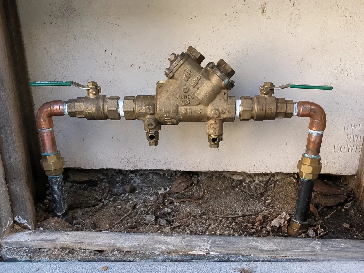 Backflow, a pressure vacuum breaker.