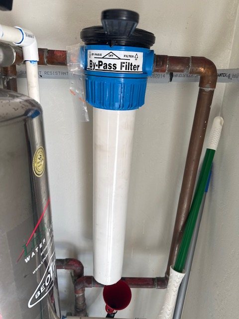 Inline bypass water filter plumbed into a main line.