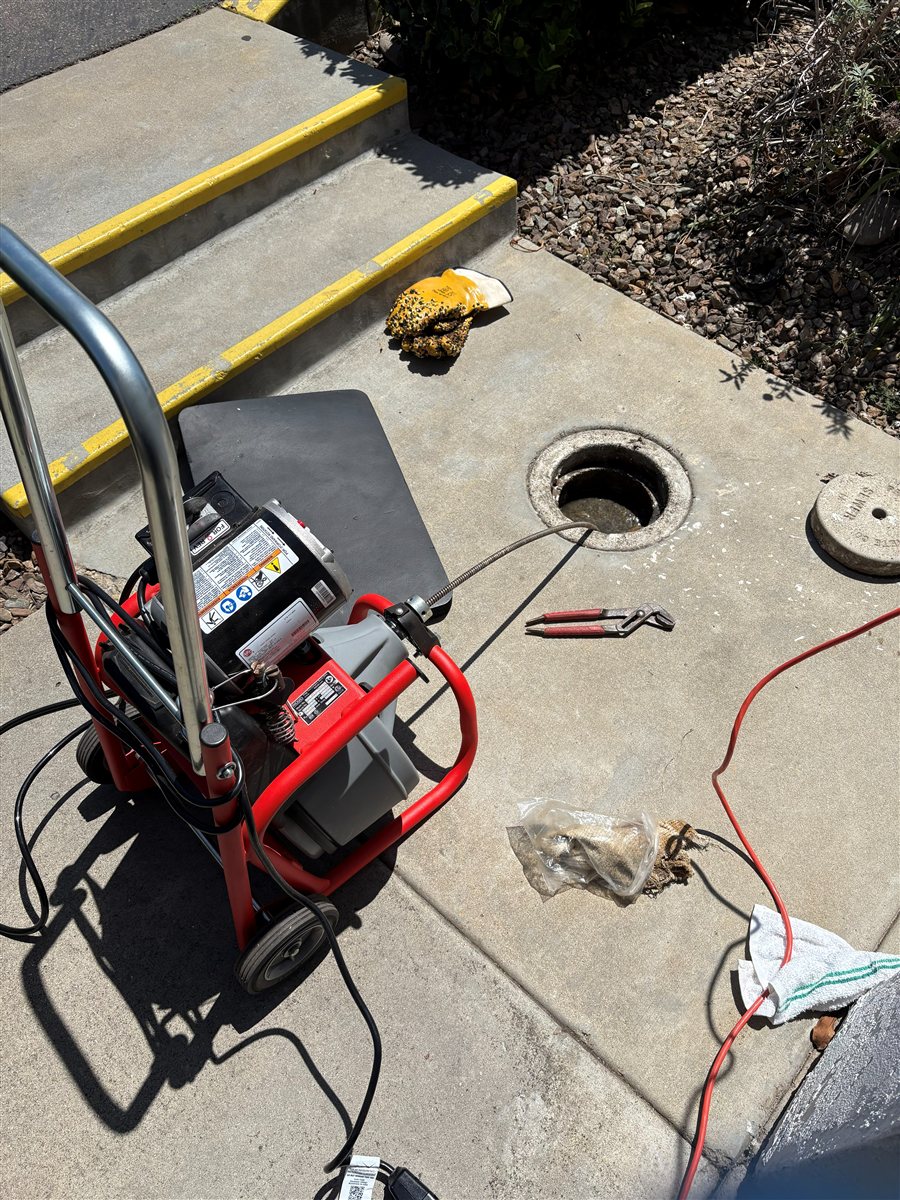 Drain cleaning machine at a cleanout.
