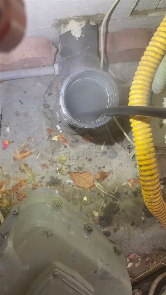 A hydro jetter running under high pressure in a cleanout