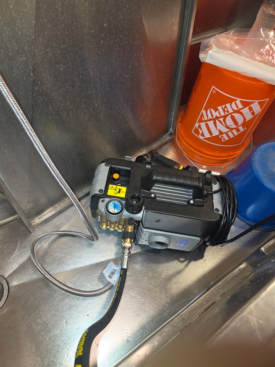 A hydro jetting pump unit hooked up to run a drain line.