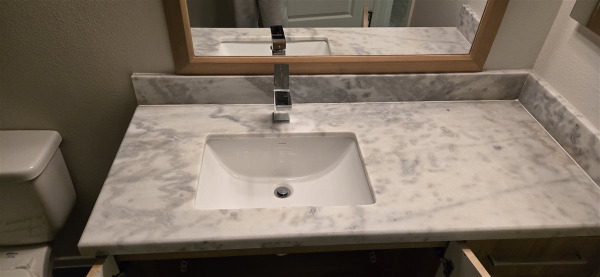 New chrome bathroom faucet installed on a vanity.
