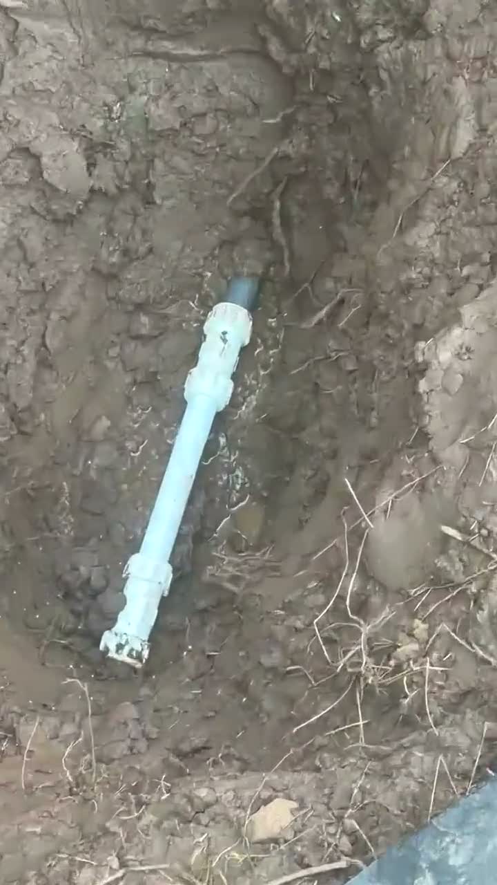 A repaired water line with new couplings in the trench, live job footage.