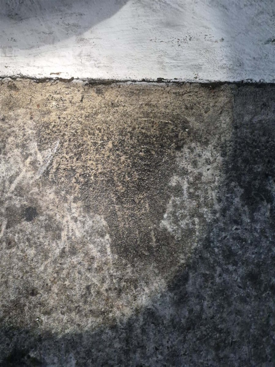 Moisture staining on a concrete slab floor.