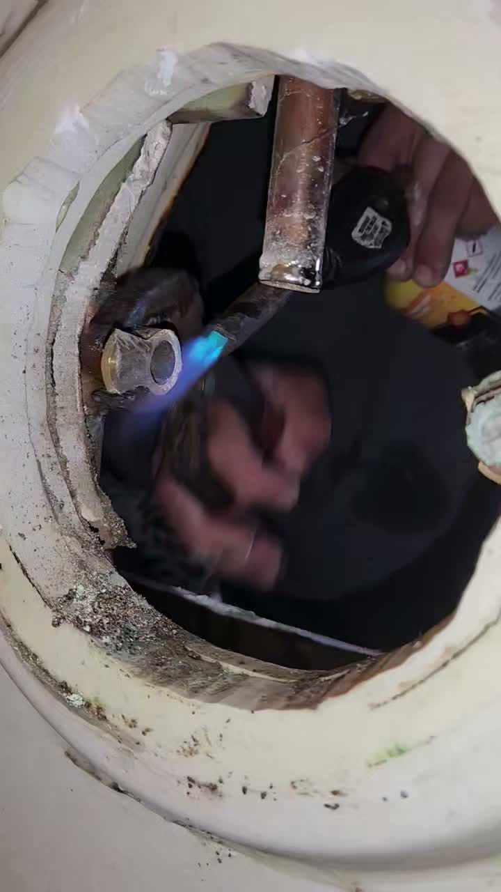 Soldering a copper pipe joint with a torch, live footage.